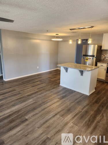 A kitchen area with a counter and cabinets.