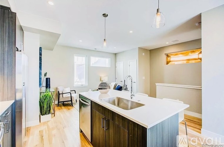 A modern kitchen with a white countertop and wooden cabinets.