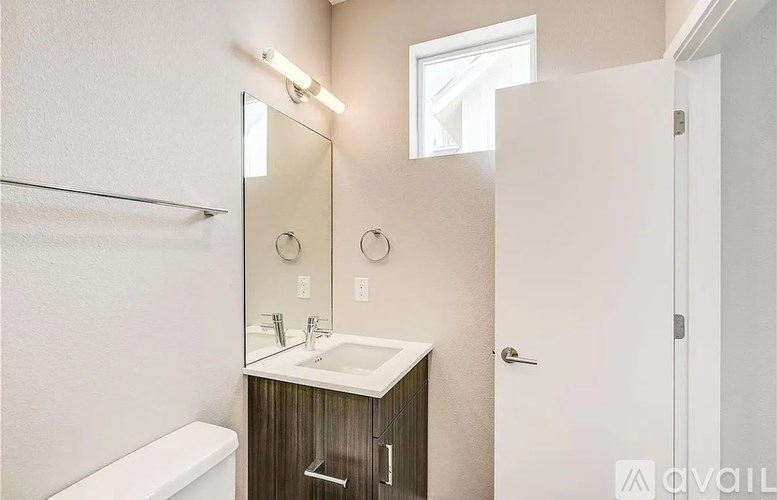A bathroom with a white sink and a white toilet.
