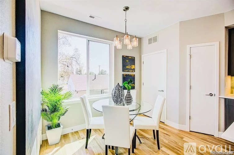 A dining room with a glass table and chairs.