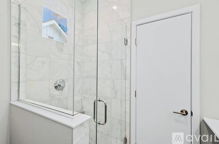 A white door is closed and has a handle on the right side.