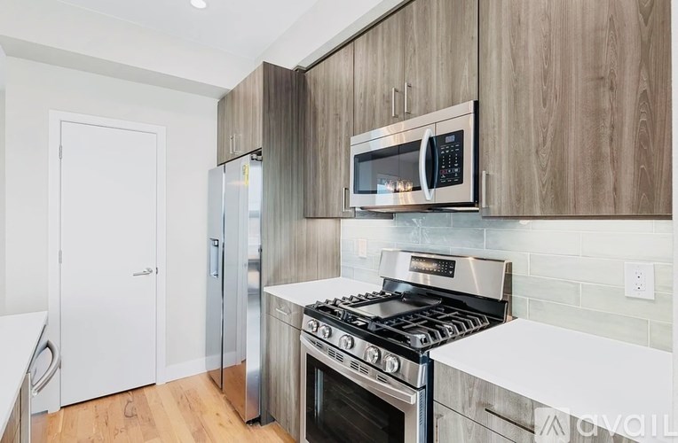 A modern kitchen with a stainless steel oven and microwave.