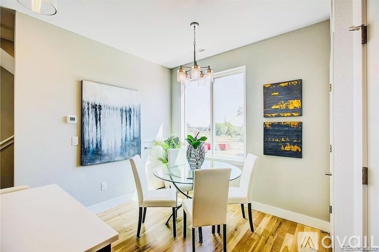 A dining room with a glass table and chairs.