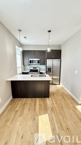 A kitchen with a wooden floor and a modern design.