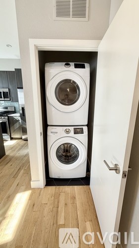 A white washing machine and dryer in a small laundry room.