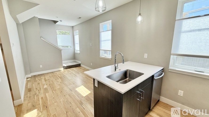 A kitchen with a sink and a window.