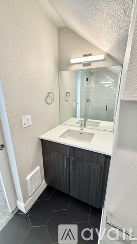 A bathroom with a sink and mirror.