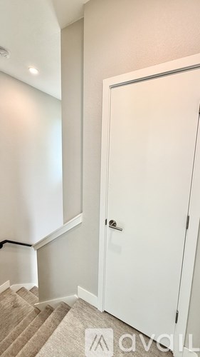 A white door is closed and has a handle on the right side.