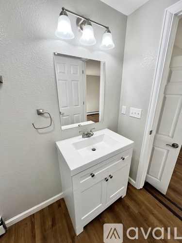 A bathroom with a white sink and a mirror above it.