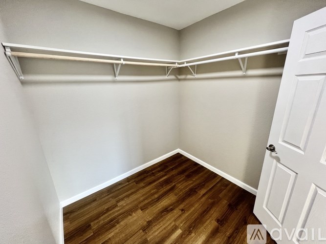 A room with a white door and a white wall with a white shelf above it.