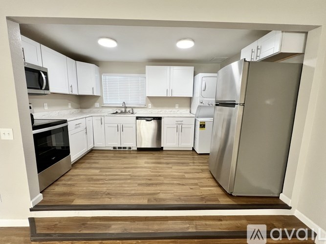 A kitchen with white cabinets and stainless steel appliances.