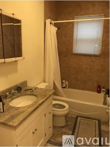 A bathroom with a sink, toilet, and bathtub.