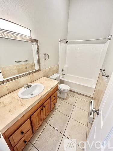 A bathroom with a sink, toilet, and shower.