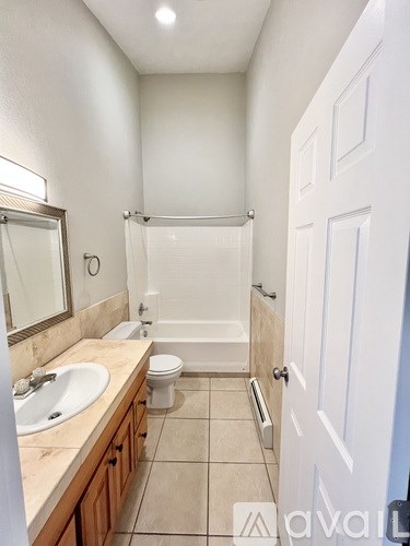 A bathroom with a sink, toilet, and bathtub.