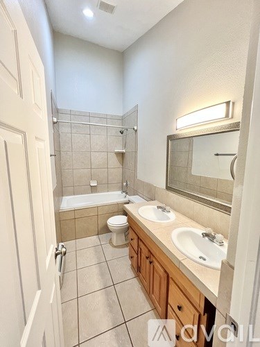 A bathroom with a toilet, sink, and bathtub.