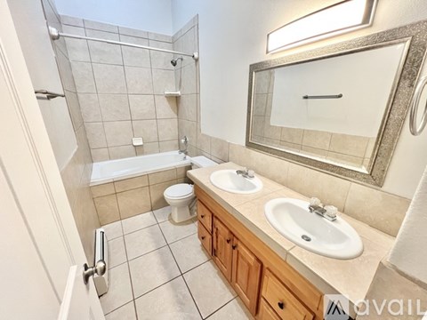 A bathroom with a toilet, sink, and shower.