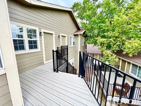 A house with a deck and a black railing.