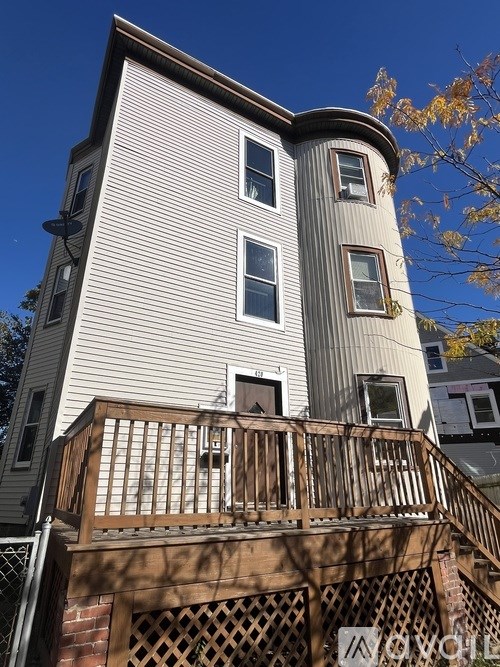 A house with a balcony and a sign that says "MOVING" on it.