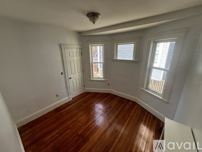 A room with wooden floors and white walls.