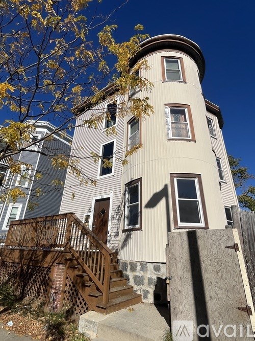 A house with a round top and a staircase leading to the door.