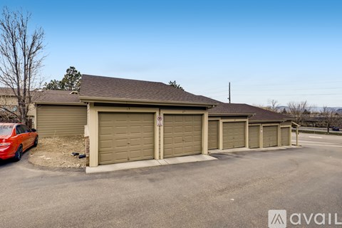 A building with a red car parked in front of it.