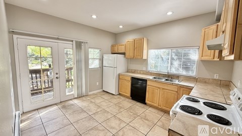 A kitchen with a stove top oven and a dishwasher.