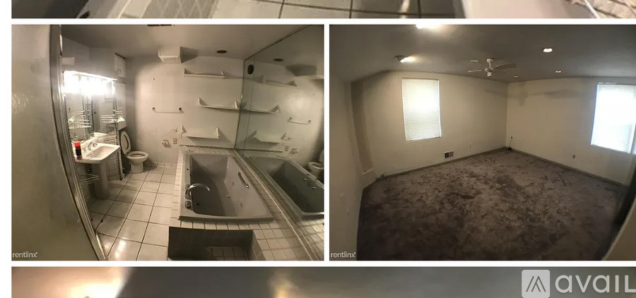 A bathroom with a tub and a toilet.