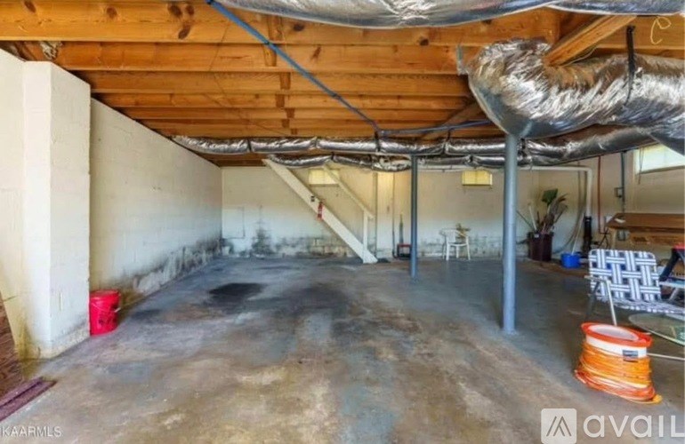 A large empty room with a wooden ceiling and ductwork.