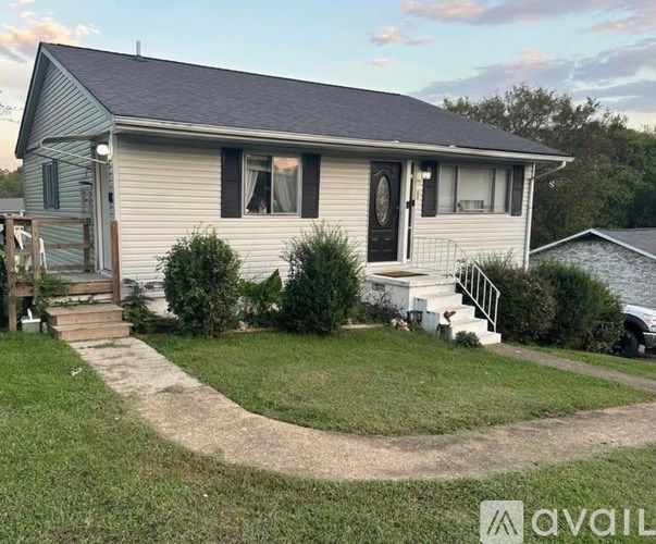 A house with a front yard and a driveway leading to the front door.
