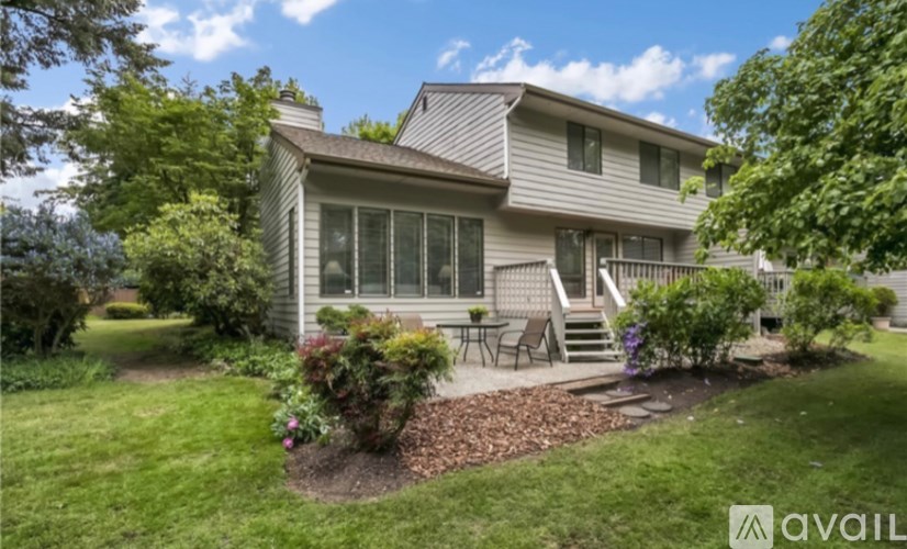 A house with a well-kept lawn and a patio area.