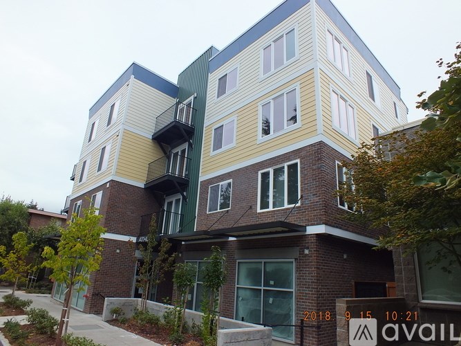 A modern multi-story building with balconies and windows.