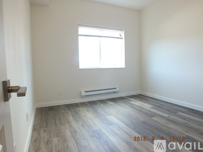 A room with wooden flooring and a window is available for rent.
