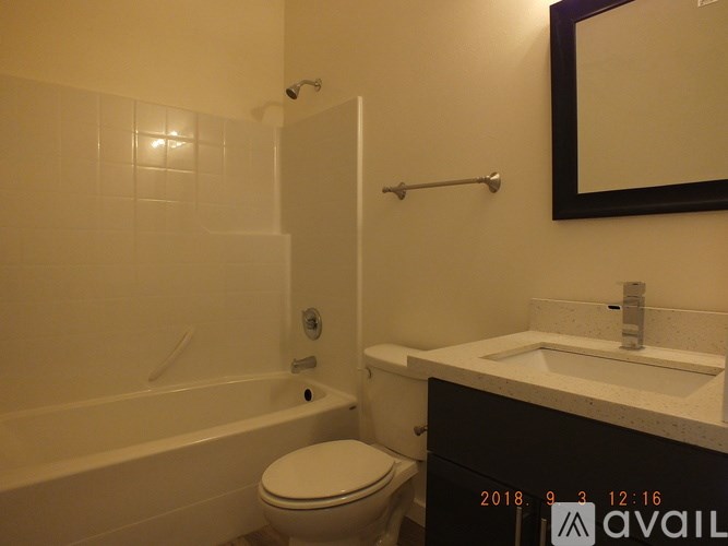 A bathroom with a toilet, sink, and bathtub.