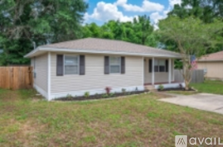 A house with a brown fence and a flag on the front.
