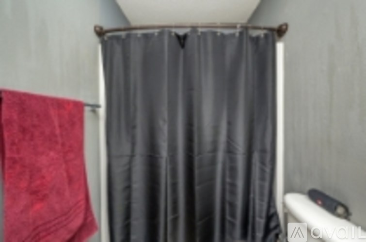 A red towel is hanging on a towel rack.