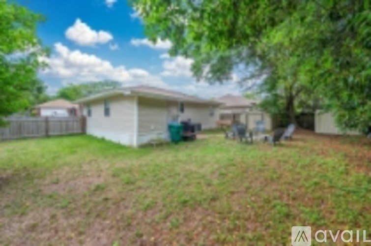 A house with a lawn and trees in front of it.