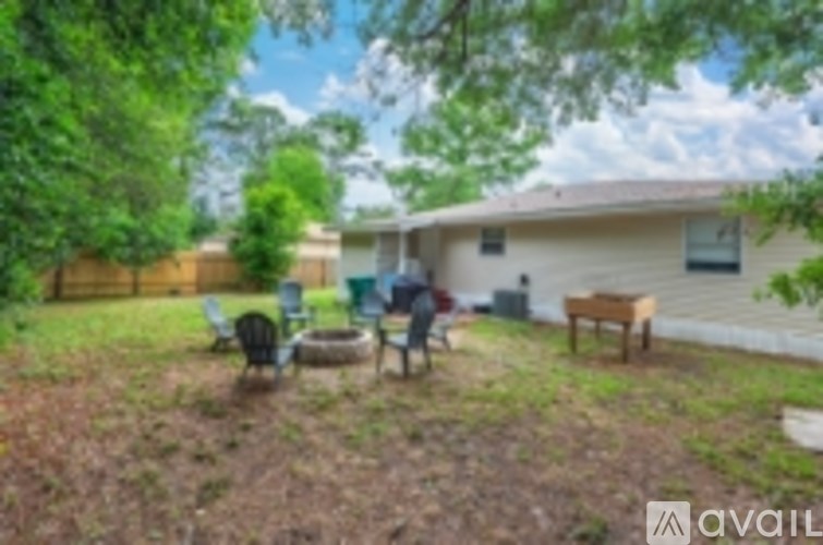 A backyard with a fence, a bench, and a table.