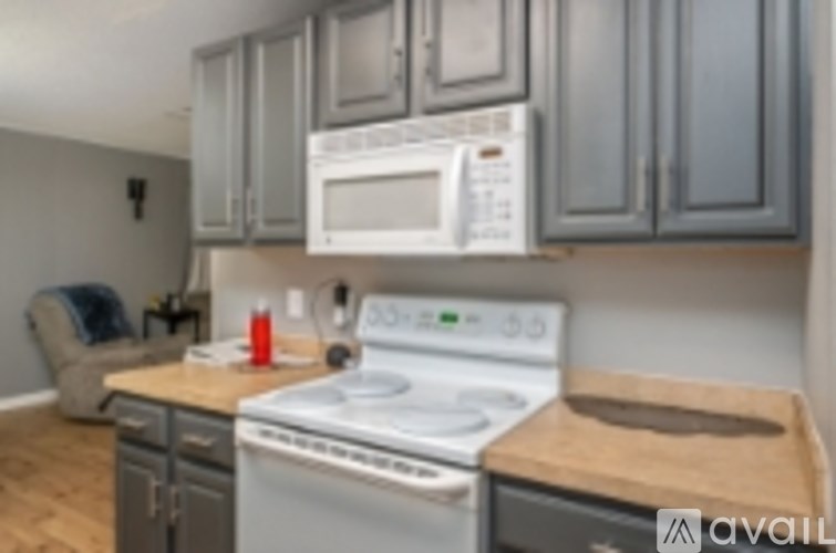 A kitchen with a stove top oven and a microwave above it.