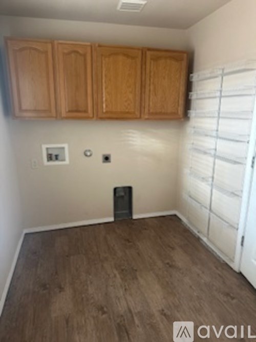 A room with wooden cabinets and a white door.
