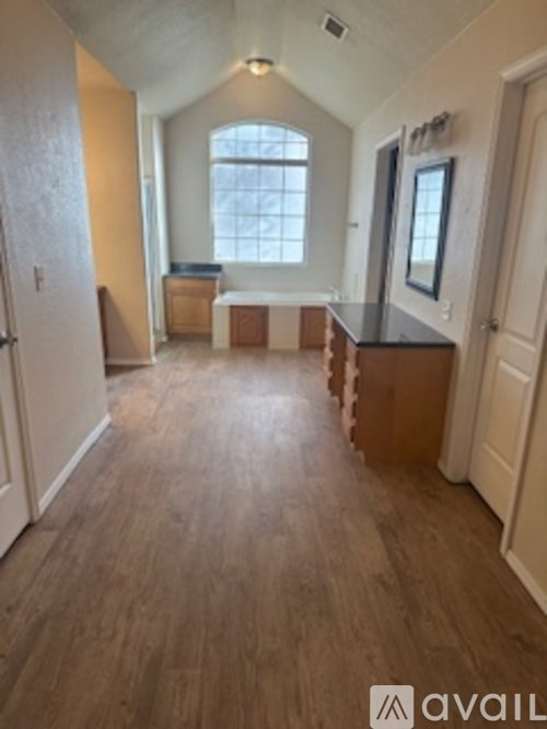 A room with wooden floors and a window.