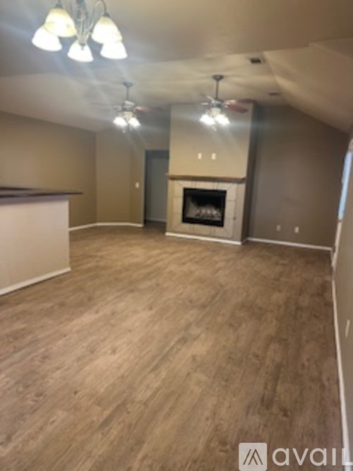 A living room with a fireplace and a television.
