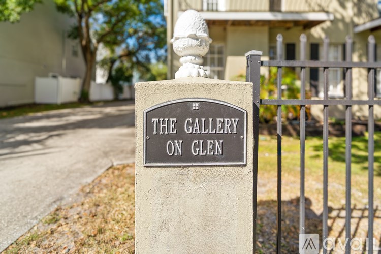 A sign that says "The Gallery on Glen" is mounted on a post.
