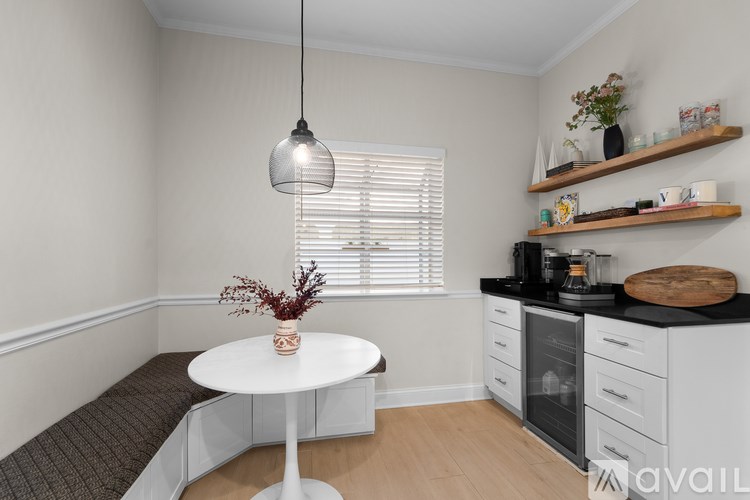 A kitchen with a table and a bench.