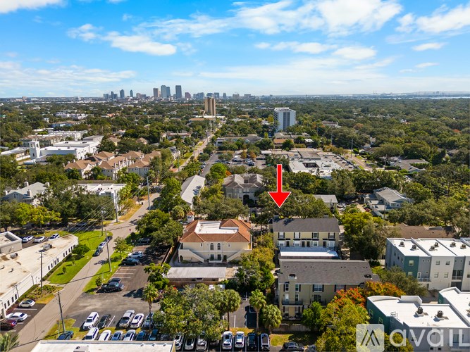 A red arrow points to a house in a suburban neighborhood.