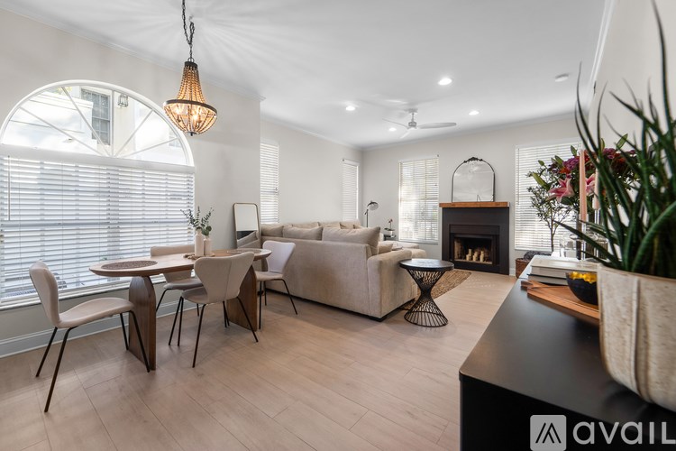 A modern living room with a fireplace and a dining table.