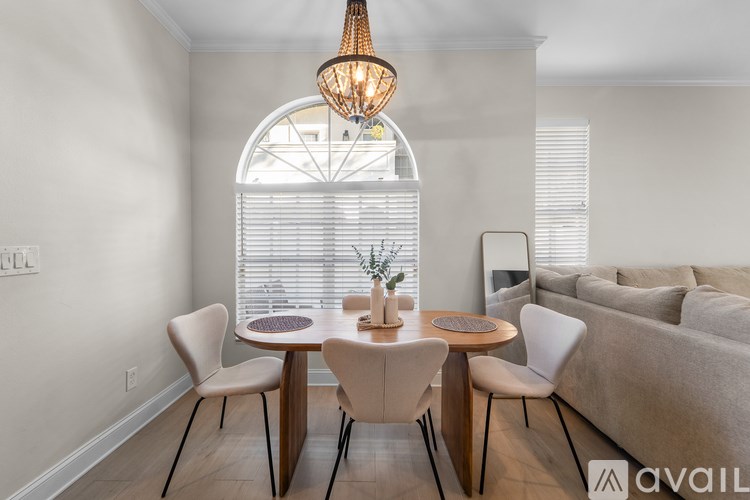 A modern dining room with a round table and chairs.