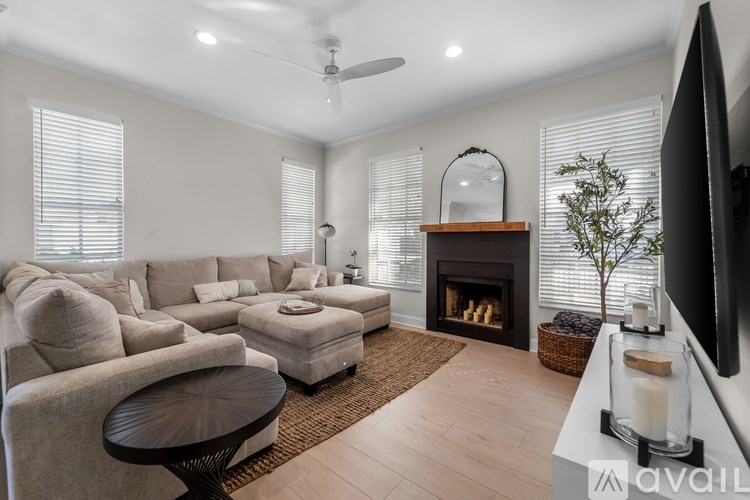 A living room with a fireplace and a television.