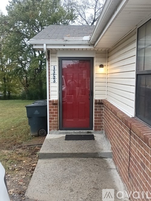 A red door is on the front of a house.