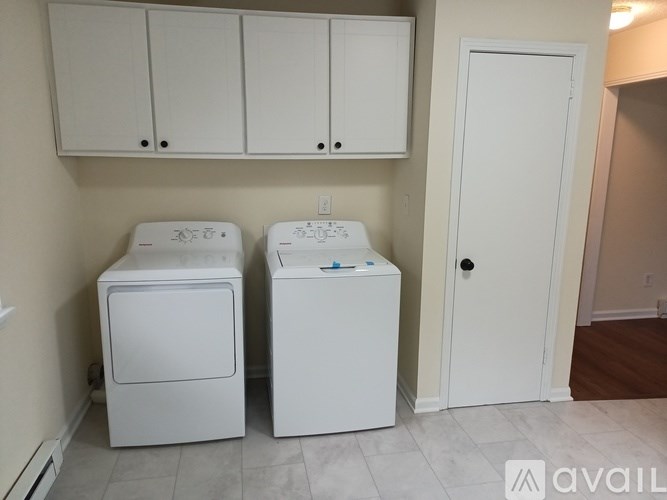 A white washer and dryer in a laundry room.