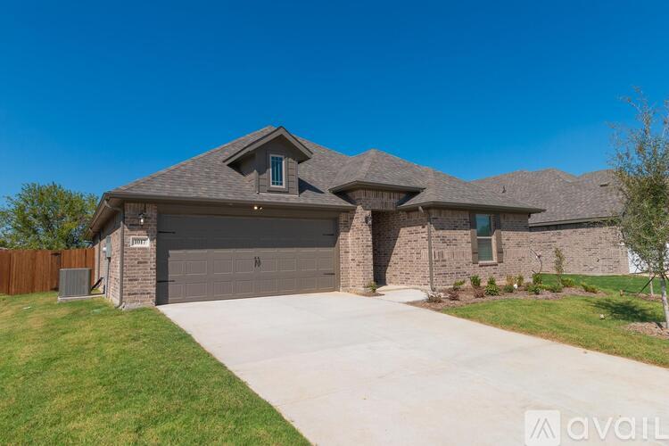 A house with a garage and a driveway is available for sale.